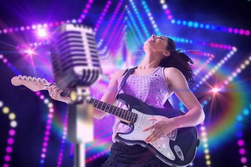 Obraz na płótnie Canvas Composite image of pretty girl playing guitar