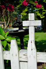 Cross on white picket fence