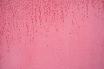 Pink wall painted textured background with drops of paint