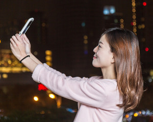 Attractive Asian Woman Taking a Selfie with Cell phone