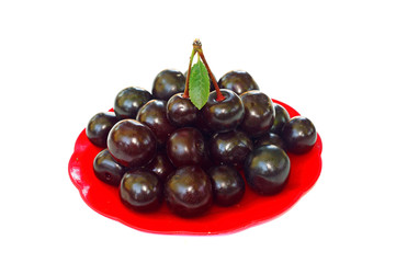 Ripe cherries in a small red platter