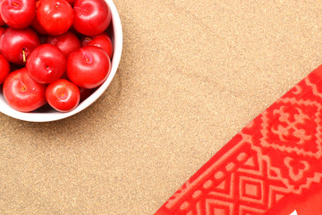 Red plums on sand on summer