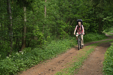 Man riding a bike in the forest road