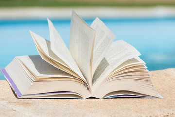 Leisure at the swimming pool with book