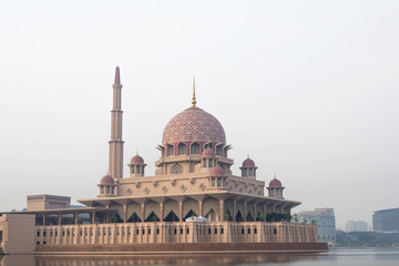 Fototapeta na wymiar Putra mosque in morning mist, Putrajaya, Malaysia