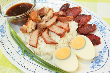 BBQ Pork, sausage, crispy pork over rice.