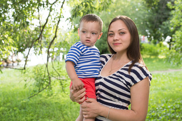 Portrait of young mother and son. outdoor.