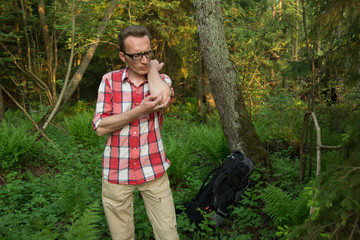 Tourist lost in woods fighting the mosquitoes.
