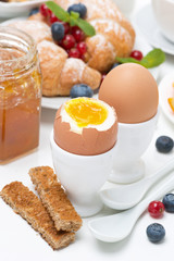 breakfast with eggs, croissants, fresh berries