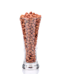 Tall glass with peanuts.