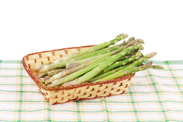 Wicker basket full with asparagus.