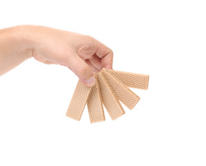 Hand holds wafer of chocolate.