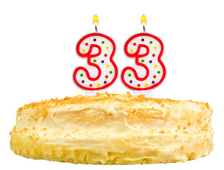 birthday cake with candles number thirty three isolated on white