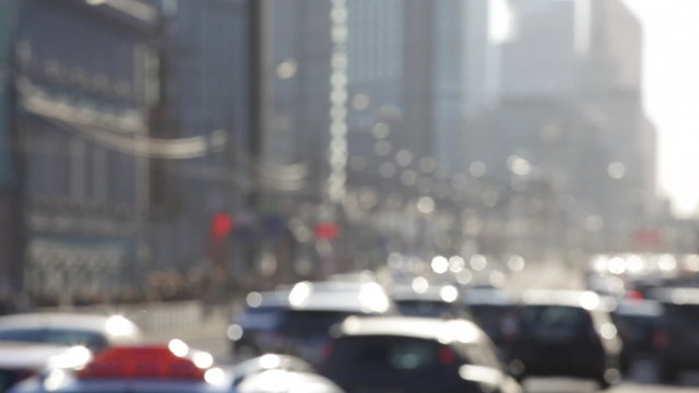 Steam of autos on the street of the big city, out of focus