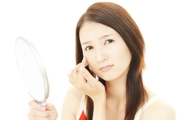 顔のシミを気にする女性