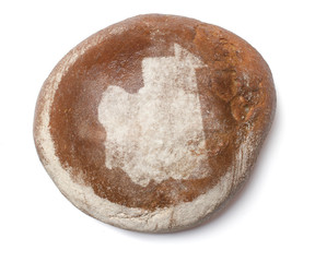 A loaf of fresh bread covered with rye flour in the shape of Mau