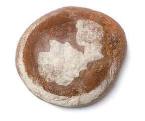 A loaf of fresh bread covered with rye flour in the shape of Zam