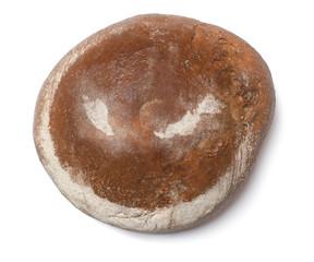 A loaf of fresh bread covered with rye flour in the shape of Mal