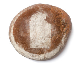 A loaf of fresh bread covered with rye flour in the shape of Nor