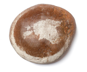 A loaf of fresh bread covered with rye flour in the shape of Est