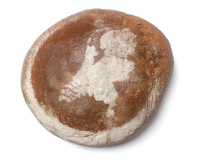 A loaf of fresh bread covered with rye flour in the shape of Net