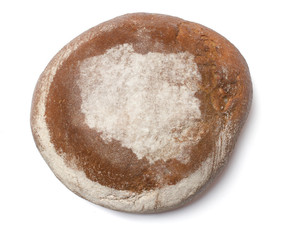 A loaf of fresh bread covered with rye flour in the shape of Pol