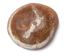 Fototapeta premium A loaf of fresh bread covered with rye flour in the shape of New
