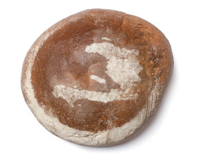 A loaf of fresh bread covered with rye flour in the shape of Hai