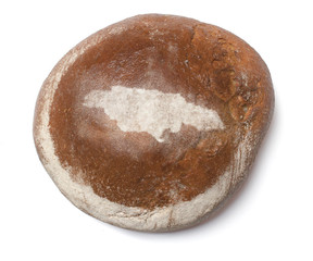 A loaf of fresh bread covered with rye flour in the shape of Jam