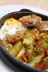 fried meat with potatoes and egg