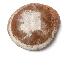 A loaf of fresh bread covered with rye flour in the shape of Ala