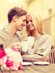 Obraz na płótnie Canvas romantic happy couple kissing in the cafe