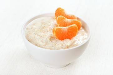 Oatmeal porridge with slices of tangerines
