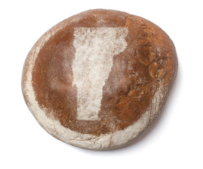 A loaf of fresh bread covered with rye flour in the shape of Ver