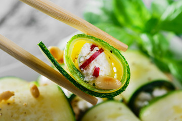zucchini rolls with feta cheese and pine nuts