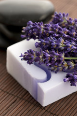 Obraz na płótnie Canvas Bar of natural soap and lavender flowers