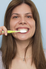 Beautiful woman brushing teeth