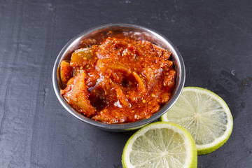 Lime pickle with lime slices on slate background