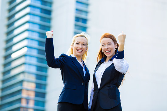 Two ecstatic business woman celebrating success