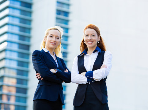 Two confident happy corporate business women