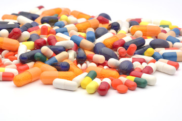 Colourful pills on white background