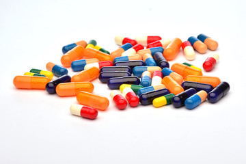 Colourful pills on white background