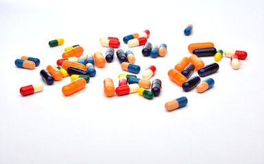 Colourful pills on white background
