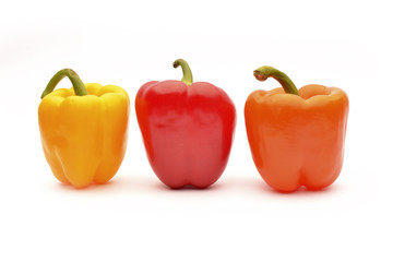Red, orange and yellow capsicum on a white background