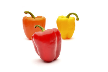 Red, orange and yellow capsicum on a white background