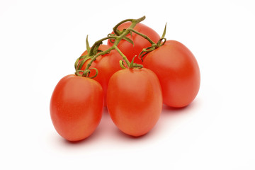 Fresh tomatoes with green leaves on white background