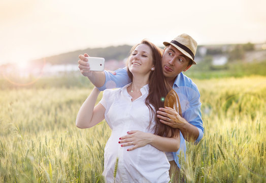 Pregnant couple taking selfie