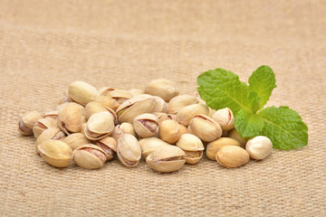 Heap of pistachios on old canvas