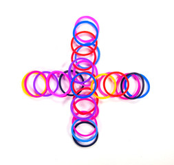 Colorful rubber band plus symbol.