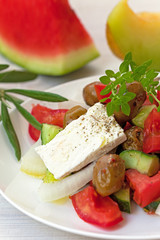 Greek salad with feta cheese, olives and basil